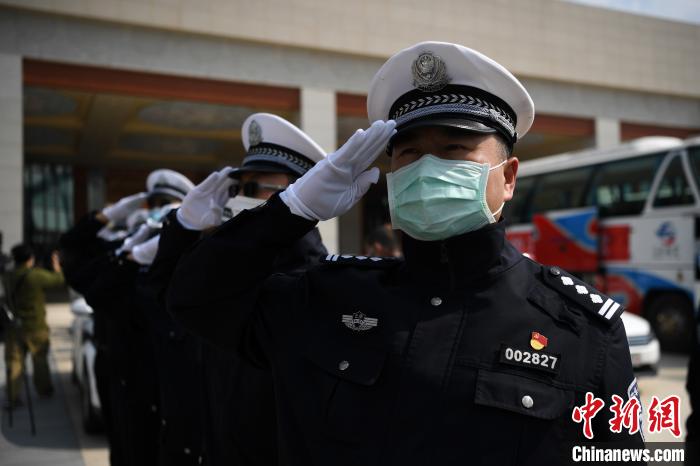 圖為交警們向醫(yī)療隊敬禮?！】灯?攝