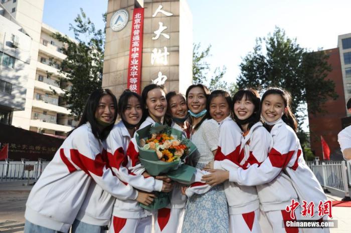資料圖：6月10日，在北京人大附中高考考點(diǎn)外，考生們相擁拍照留念。當(dāng)日，北京市2021年高考結(jié)束?！?<a target='_blank'  data-cke-saved- ><p  align=